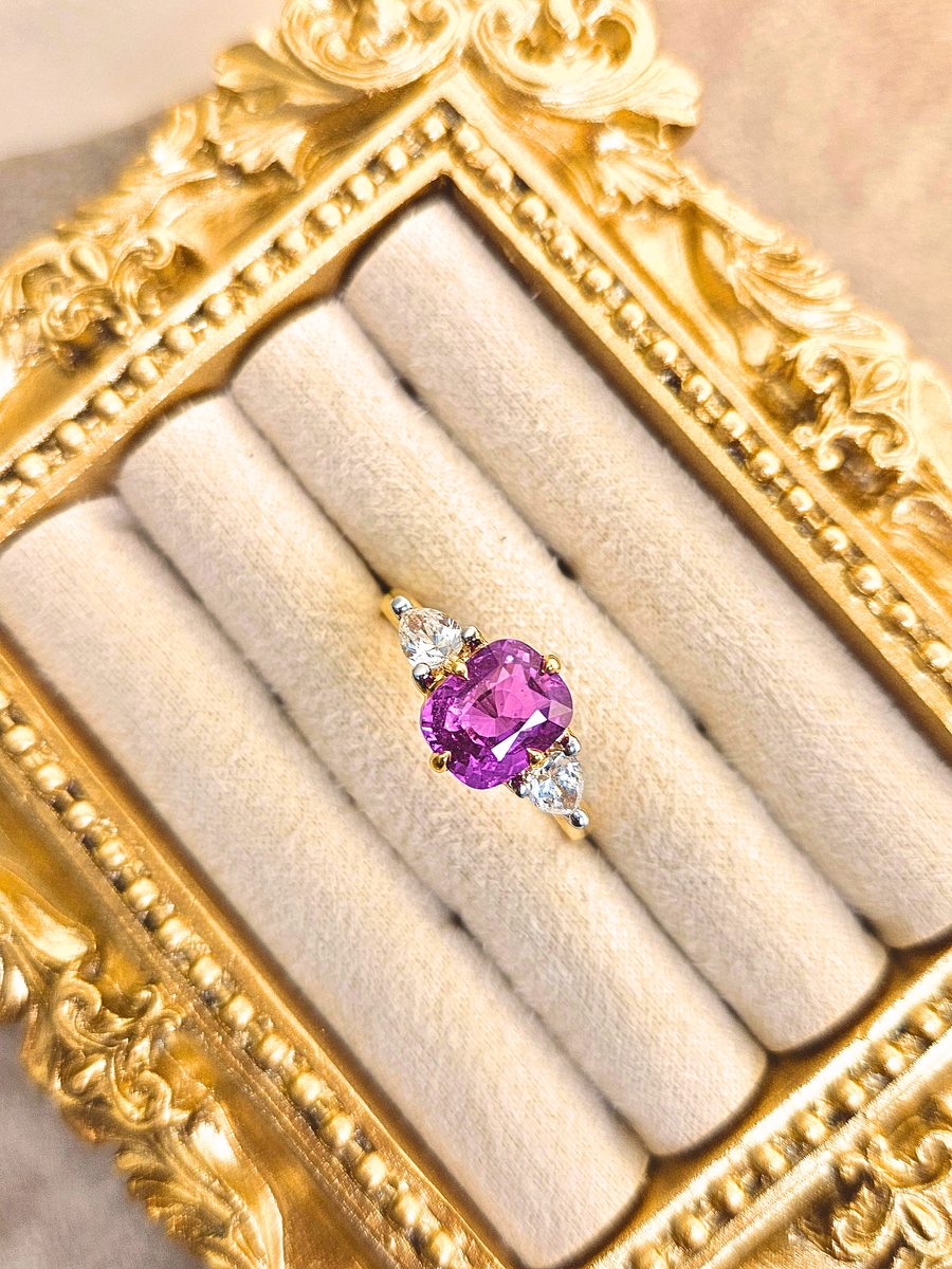 Custom pink sapphire oval ring with pear-cut diamond shoulders in gold, crafted by Safir Jewellery & Gems